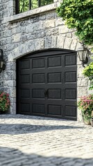 Closed modern garage door with stone arched entry, flowers, and light fixtures by a stone paved path