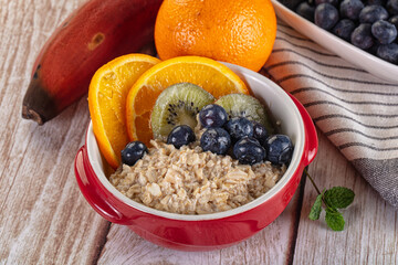 Oats porridge with blueberry, kiwi and orange