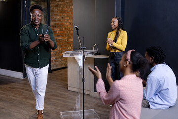 Diverse professionals applauding colleague after presentation in modern office setting, copy space