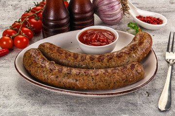 Grilled beef sausages with sauce