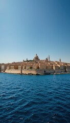 Fototapeta premium Serene Coastal View of Historical City under Clear Blue Sky
