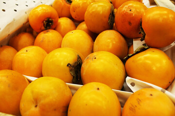 Close-up of yellow persimmons. Yellow Fruit Background