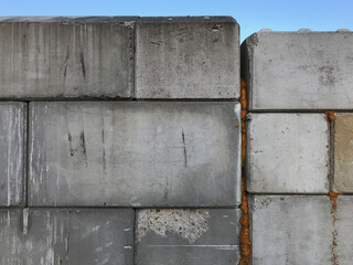 Close-up of large, interlocking concrete blocks, emphasizing their textured, weathered surfaces. The composition focuses on the interplay of rigid lines, the simplicity and rugged beauty of the scene.