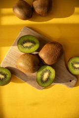 Kiwi on a wooden board. on a yellow background. fruit