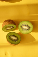 Kiwi on a wooden board. on a yellow background. fruit