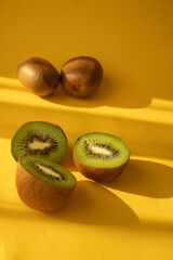 Kiwi on a wooden board. on a yellow background. fruit