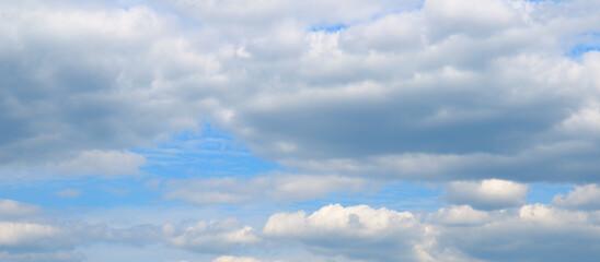 Blue sky and light cumulus clouds.