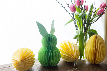Stylish Easter eggs and Easter bunny paper honeycomb decoration on rustic table with flowers at...