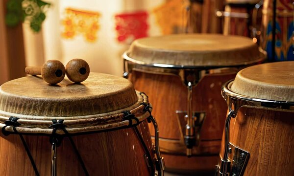 Wooden bongos with mallets, festive Mexican decor in background