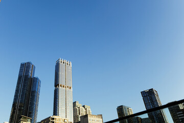 Modern skyscrapers reaching for the clear blue sky in a bustling metropolis