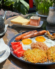 Enjoy a hearty breakfast with fluffy eggs, savory sausage, and other tasty treats to start your day