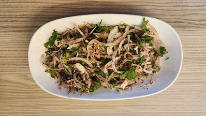 A tangy onion salad with plenty of sumac, commonly served as a side dish in kebab menus.