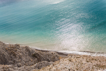 A stunning view of the seascape from a steep rocky cliff, the azure surface of the Black Sea in the...