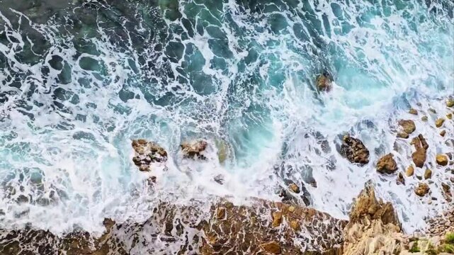 Foaming waves crashing against rocks in Petrovac, Montenegro.