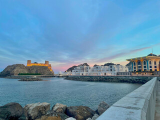 Enchanting Sunset over Old Muscat, Oman: Picturesque Al Alam Palace and Traditional Architecture Illuminated by Colorful Sky