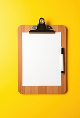 Wooden clipboard with blank white paper and pen on yellow background, pen, vintage, empty