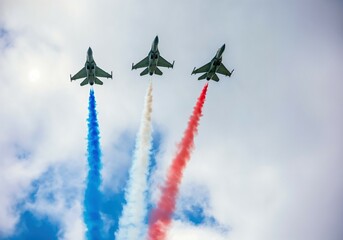 Three fighters in a harsh form, leaving red, white and blue smoke of the flag of France