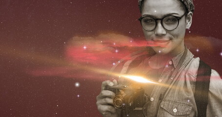 Young woman holding camera, exploring space-themed digital art with curiosity