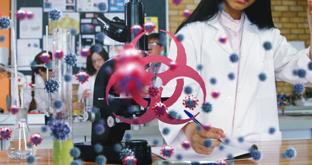 Scientists in lab coats conducting research with microscope and virus graphics