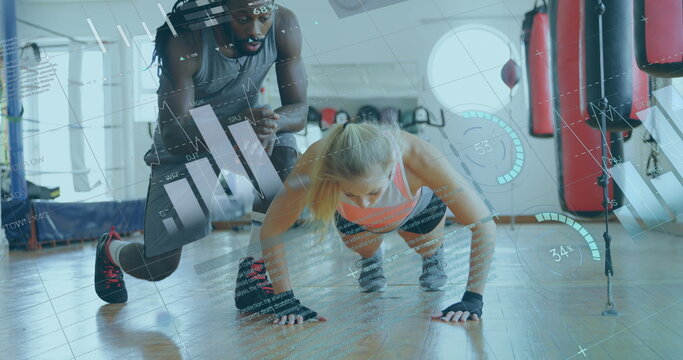 African American trainer coaching woman doing push-ups, digital interface overlay