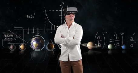 Using VR headset, man exploring virtual solar system and mathematical graphs