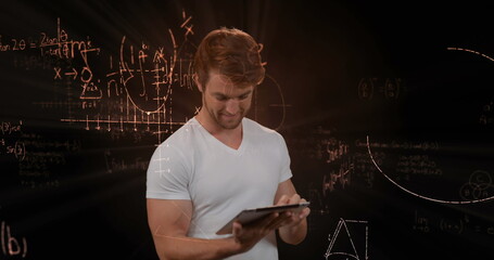Using tablet, man surrounded by floating mathematical equations, focused on learning