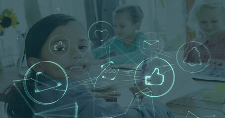 In classroom, children interacting with digital icons while studying together