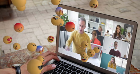Virtual meeting on laptop screen, floating emojis enhancing digital interaction