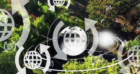 Image of globe icons with arrows and globe spinning over landscape