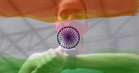 Image of woman wearing face mask during exercise over indian flag