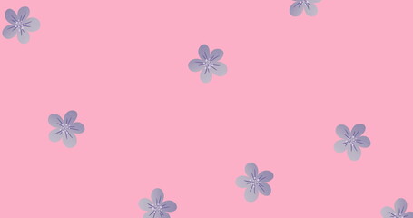 Image of multiple blue flowers moving over pink background