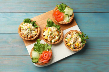 Tartlets with delicious fillings on blue wooden table, top view