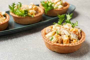Tartlets with delicious filling on grey table, closeup