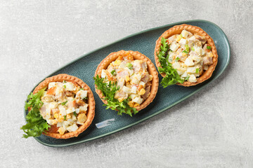 Tartlets with delicious filling on grey table, top view