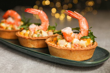 Tartlets with delicious filling on grey table, closeup. Bokeh effect