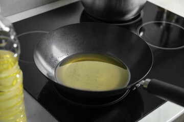 Used cooking oil in frying pan on stove in kitchen