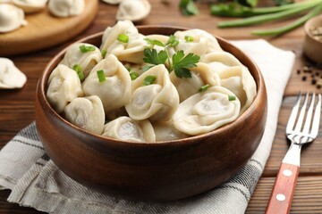 Delicious dumplings served on wooden table, closeup