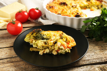Tasty vegetable casserole on wooden table, closeup