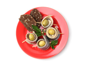 Delicious herring rolls with olives, parsley and bread on white background, top view