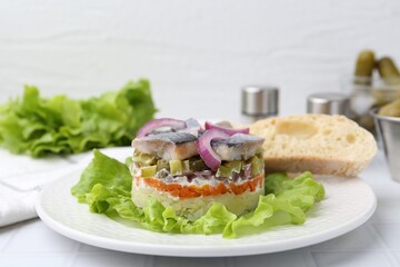 Delicious salad with herring, vegetables and bread on white table, closeup