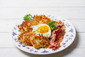 Potato Cakes. Vegetable fritters, latkes, hash browns. Vegetable pancakes with fried egg and bacon