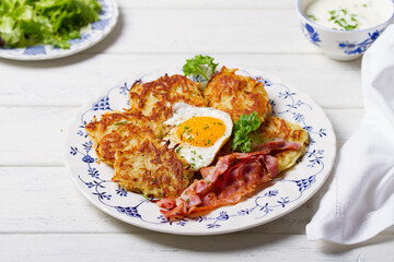 Potato Cakes. Vegetable fritters, latkes, hash browns. Vegetable pancakes with fried egg and bacon