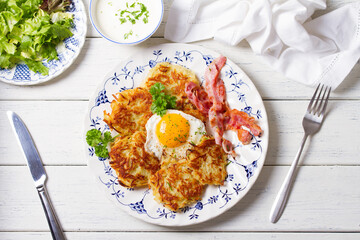 Potato Cakes. Vegetable fritters, latkes, hash browns. Vegetable pancakes with fried egg and bacon. High angle view
