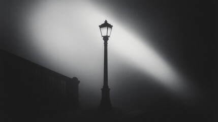 A streetlamp glowing through a thick mist casting eerie shadows.