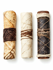 Rolled ancient scrolls tied with twine on white
