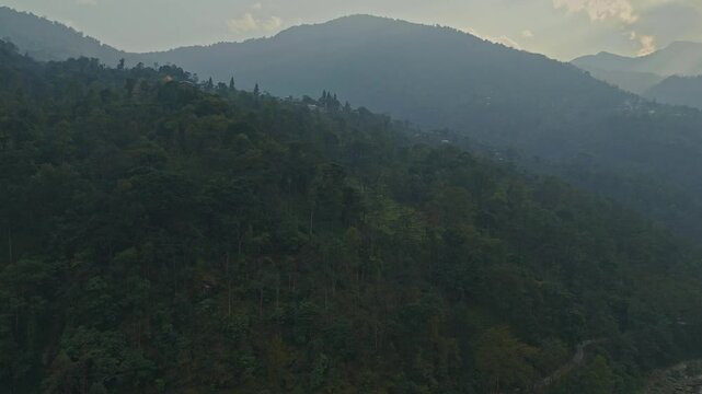 Aerial 4K drone shot of foggy Pelling, Sikkim, North India. Bird's-eye view of the Himalayas, dense jungle, D Log, and Skywalk with stunning mountain scenery and Northeast travel footage.