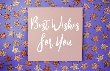 Best Wishes For You text on paper card with star glitter decoration flat lay on purple background
