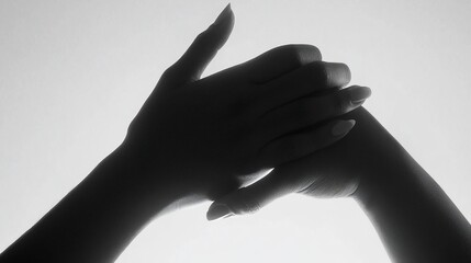 Monochrome silhouette capturing a pair of hands intertwined in an artistic display