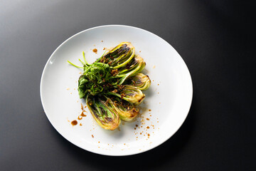 Fresh bok choy boasts vibrant greens and rich sauces, highlighting Asian culinary art.