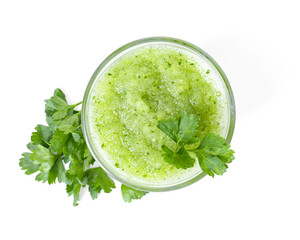 Healthy parsley smoothie in glass and leaves isolated on white, top view